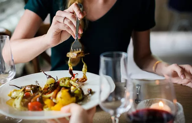 Woman eating vegetables