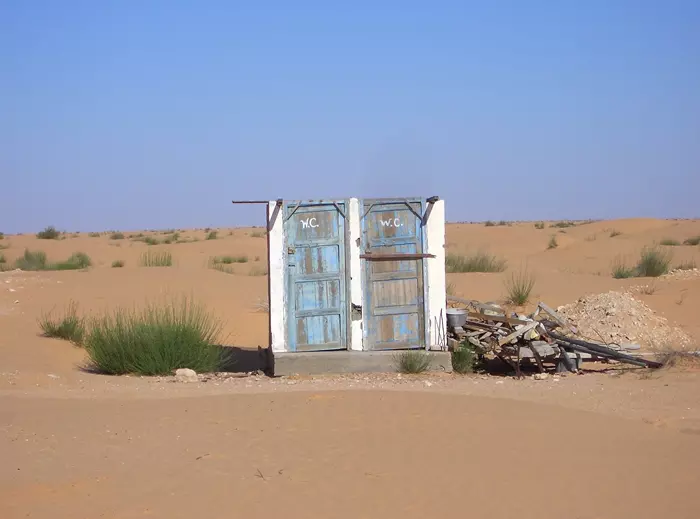 Doors of the destroyed public toilets in the desert